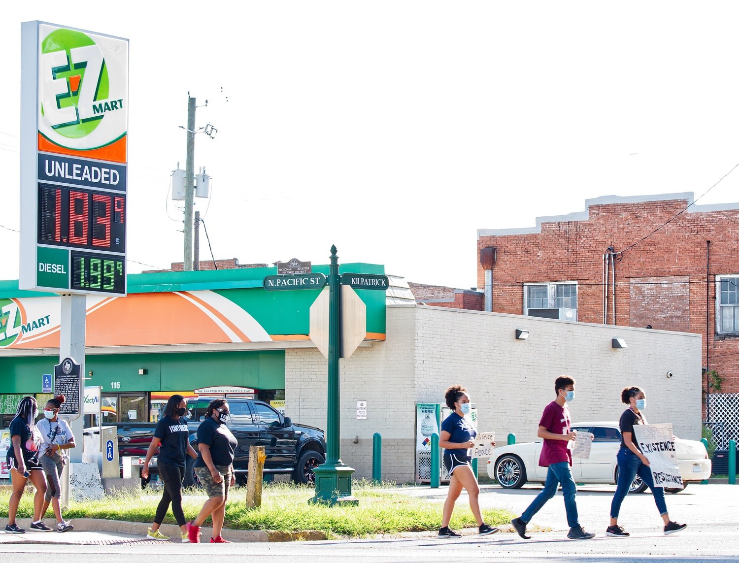The marchers proceed past the old 7-11, near the location of Chris Griffin's killing at the hand of law enforcement.